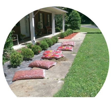 adding mulch to a residential lawn
